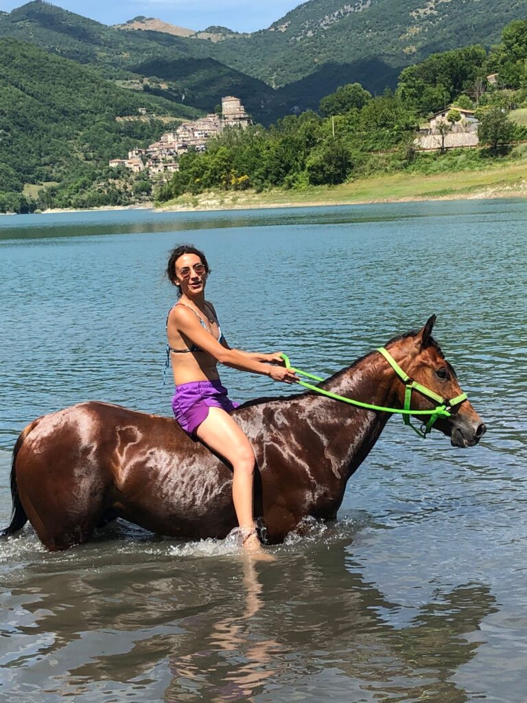 Jessica riding horse into a lake