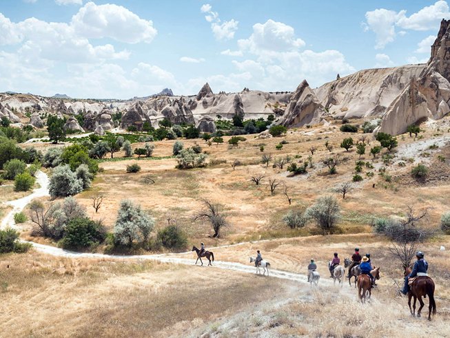 horse riders in cappadocia valley