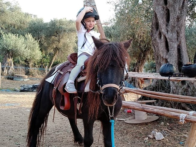Horse riding holidays in Greece: kid riding a horse