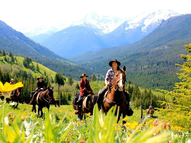 Group riding between the mountains during a Ranch vacations in Canada