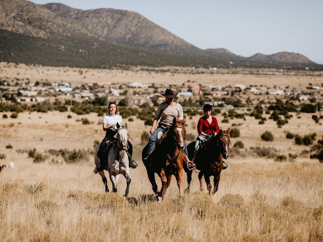 people galloping in the new mexico desert