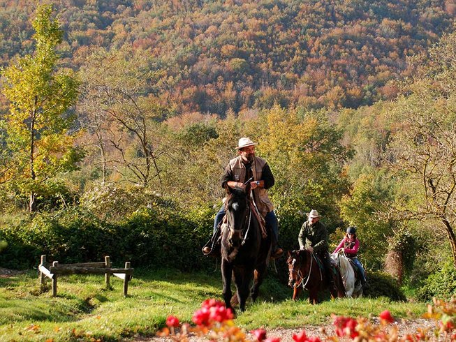 Group horse riding in the Tuscany countryside