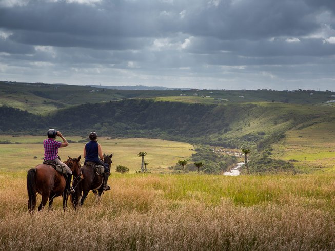 horse riders in a valley in south africa