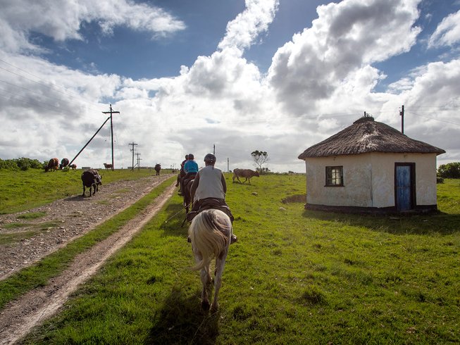 horse riders in a village